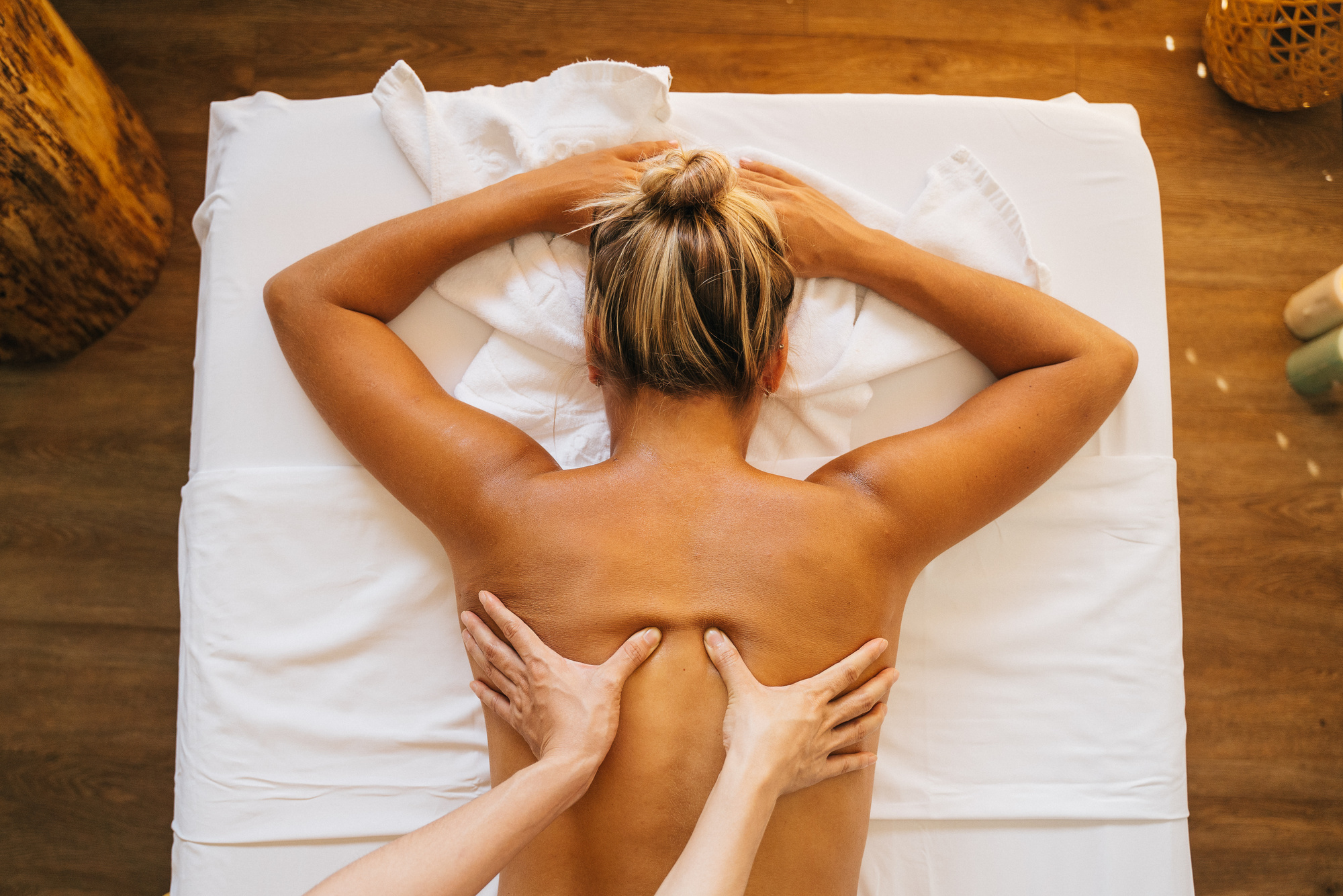 A Topless Woman Lying on Massage Table while Getting a Massage